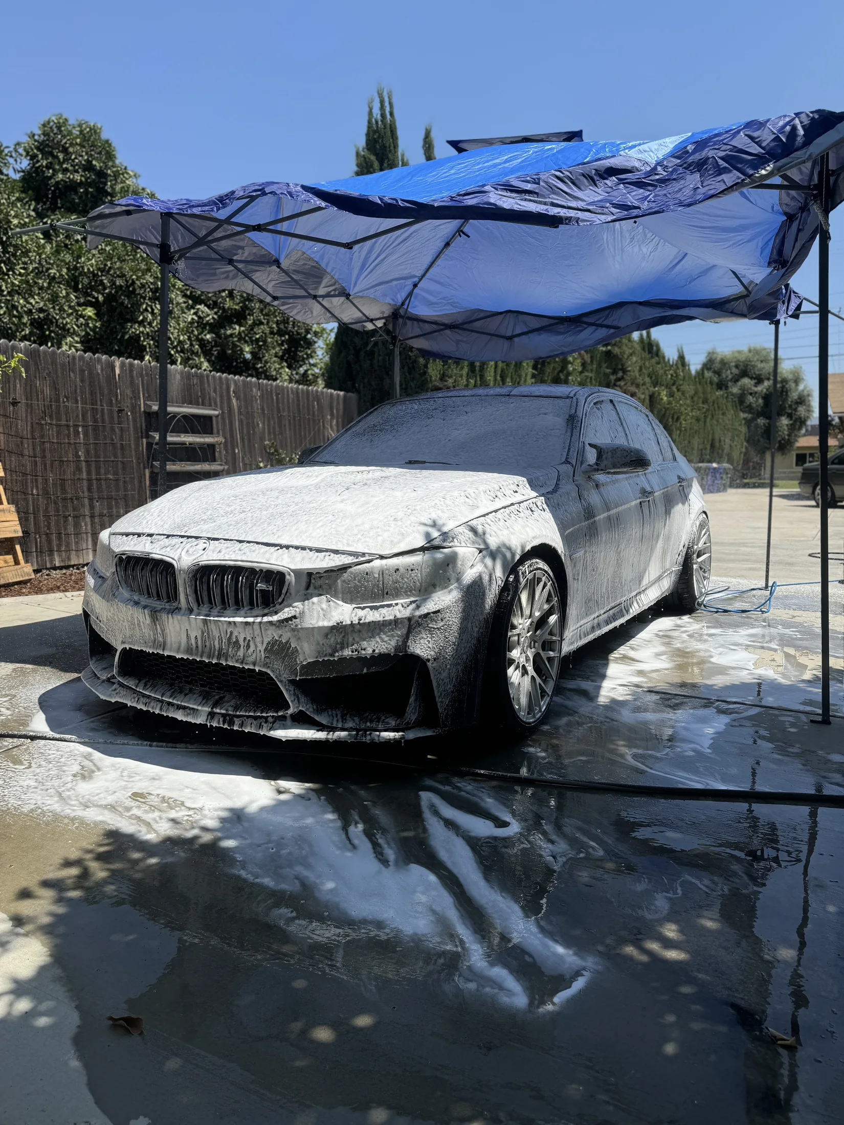 BMW M3 covered in foam during a paint-safe exterior wash