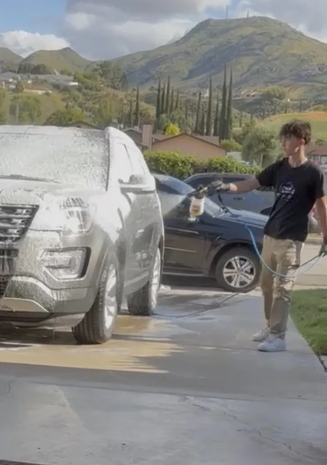 Gabriel Lorentz foam washing an SUV during a G&S mobile detailing appointment