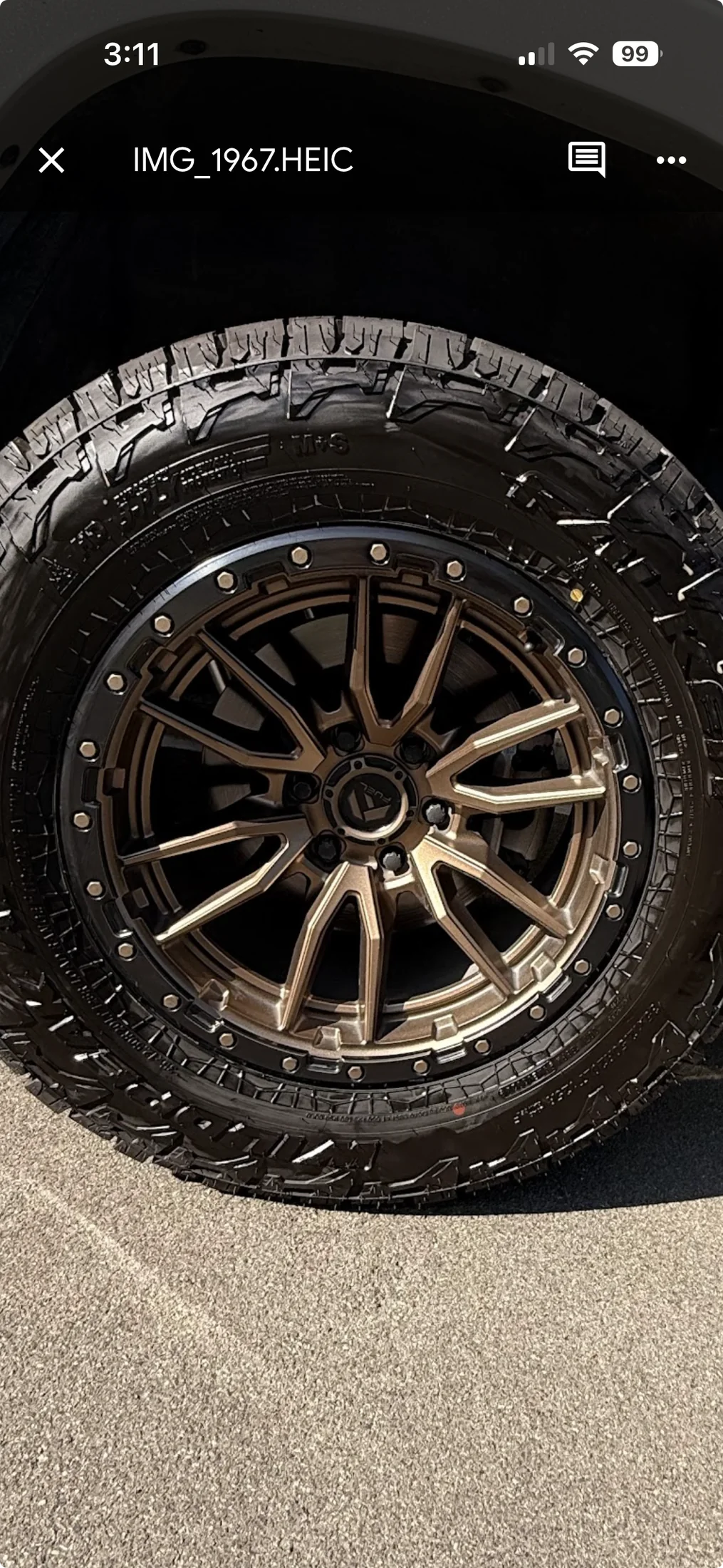 Clean wheel and dressed tire after exterior detailing